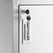The hinged door with a lock on a Regency stainless steel corner sink cabinet.