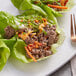 A plate of lettuce wraps with Kinikin Rocky Mountain ground beef and vegetables.