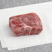 A piece of Kinikin Processing raw sirloin steak on white paper.