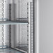 The interior of an Avantco stainless steel reach-in refrigerator with metal shelves.