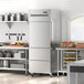 An Avantco stainless steel reach-in refrigerator with drawers in a kitchen.