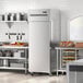 An Avantco stainless steel reach-in freezer in a kitchen.