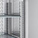 The interior of an Avantco stainless steel reach-in refrigerator with metal shelves and drawers.