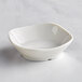 A Tablecraft white mini melamine bowl with rounded square corners.