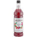 A Monin bottle of strawberry rose syrup.