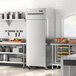 An Avantco stainless steel reach-in refrigerator in a kitchen.