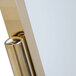 A close-up of a shiny brass Aarco double pedestal poster stand.