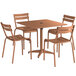 A Lancaster Table & Seating brown aluminum dining table with an umbrella hole and four chairs on a wooden table.