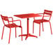 A Lancaster Table & Seating red powder-coated aluminum table and 2 chairs.