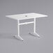 A white rectangular Lancaster Table & Seating outdoor dining table with metal legs.
