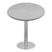 A round white quartz table top on a metal base.