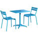 A blue table and two chairs set up on a white background.