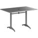 A Lancaster Table & Seating matte gray aluminum table with an umbrella hole.