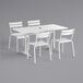 A white Lancaster Table & Seating dining table with 4 white chairs.
