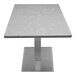 A white rectangular table with a Nebula Gray quartz tabletop and a metal base.