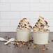 Two cups of Rich's vanilla oat milk soft serve with sprinkles and chocolate chips.