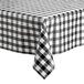 A Choice black and white checkered vinyl table cover with flannel back on a table.