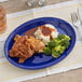 An Acopa blue melamine oval platter with chicken, mashed potatoes, and broccoli on a table.