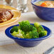 An Acopa Foundations blue melamine bowl filled with broccoli.