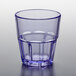 A clear plastic tumbler with a blue rim on a table.