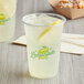 A plastic Carnival King lemonade cup filled with lemonade, ice, and a straw.