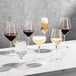 A group of Della Luce Astro white wine glasses on a table.