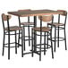 A Lancaster Table & Seating bar height butcher block table with wooden top and four boomerang chairs.