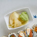 A plate of sushi rolls with Thunder Group Blue Bamboo rectangular sauce dishes filled with ginger on a table.
