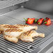 A Crown Verity built-in horizontal drawer with chicken and peppers cooking on a grill.