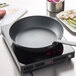 A Spring USA LoPRO Slim-line induction range on a countertop with a pan on it.
