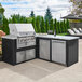 A Crown Verity built-in horizontal storage compartment with drawers next to a Crown Verity built-in grill on a patio.