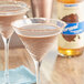 A close-up of two glasses of Torani Puremade Zero Sugar Chocolate Flavoring Syrup in chocolate martinis.
