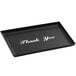 A black rectangular tray with silver text that says "Thank You"