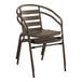 A Lancaster Table & Seating bronze metal outdoor arm chair with a wooden curved back.