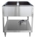 A Vollrath stainless steel ServeWell electric hot food table with two pans on a counter.