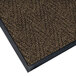 A brown Lavex carpet entrance mat with black trim in a chevron pattern.