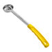 A Choice yellow portion spoon with a perforated silver bowl and handle.