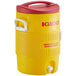 A yellow and red Igloo insulated beverage dispenser with lid and handle.