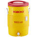 A yellow and red Igloo insulated beverage dispenser with lid.