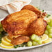 McCormick Culinary Rotisserie Chicken Seasoning on a plate with lemon wedges and grapes.