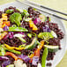 A plate of Campanini Venere black rice with vegetables and chopsticks.