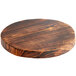A Front of the House ROOT round wooden serving board with a black finish.