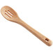 An OXO wooden slotted spoon with a long handle and a hole in it.
