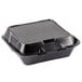 A black foam Genpak food container with a hinged lid.