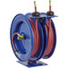 A blue and red Coxreels hose reel with two red hoses.