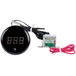 A black round digital temperature gauge with wires.