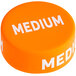 A medium orange silicone lid wrap with white text that reads "First In First Out" in a round medallion.
