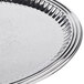 A Vollrath stainless steel oval fluted tray with a decorative design.