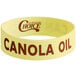 A yellow silicone wristband with brown text that says "Choice Canola"