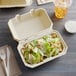 A salad in a Tellus Products bagasse hoagie container.